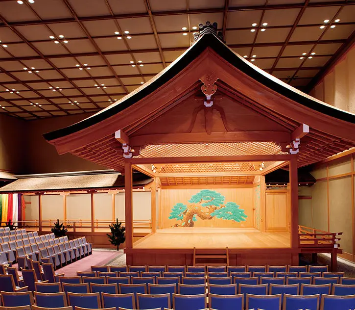 Poster for Japan Raga Sagara in Nara: Sri Swamiji in saffron robes with concert details for 29 November 2026 at the I·RA·KA Noh Theater Hall.
